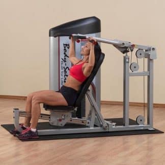 machine de musculation femme brassière rouge et en short noir fait des exercices pour se muscler
